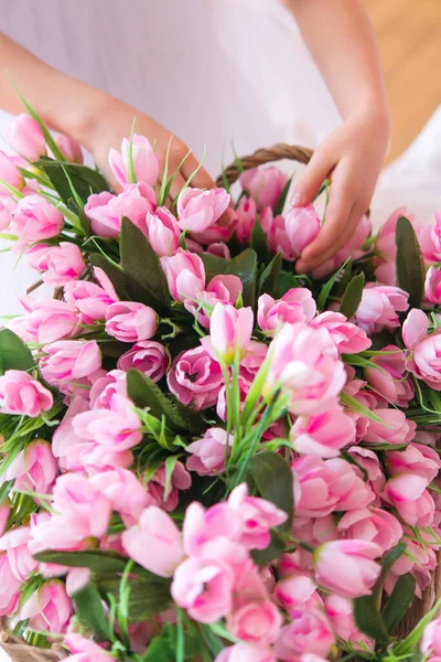 basket with flowers, tulips. Hands holding flowers. Concept, congratulations on the holiday, birthday, anniversary. copy space