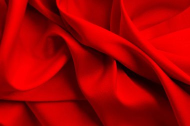 Kırmızı ipek ya da saten lüks kumaş dokusu soyut bir arka plan olarak kullanılabilir. Üst görünüm.
