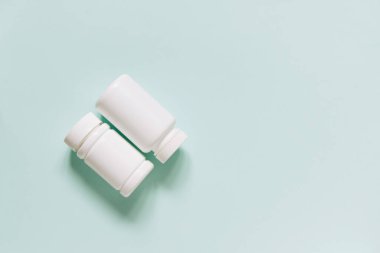 Set of various white medicines, mockup, pill bottles without label design, copy space on blue background
