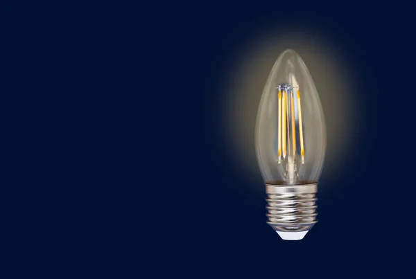 Light Bulb Isolated Blue Background Glowing Yellow Energy Saving Light — Stock Photo, Image