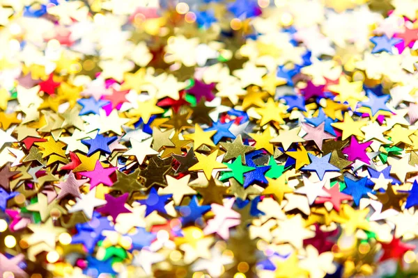 Multi-colored shining stars close-up. Festive holiday background.