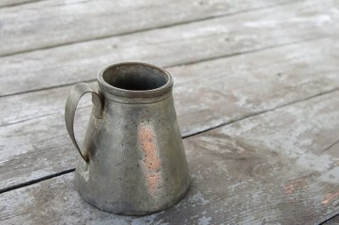 Eski antika vazo, bakır sürahi, eski ahşap bir masada sapı olan tencere. Boş bir nesnenin en küçük konsepti, maketi.
