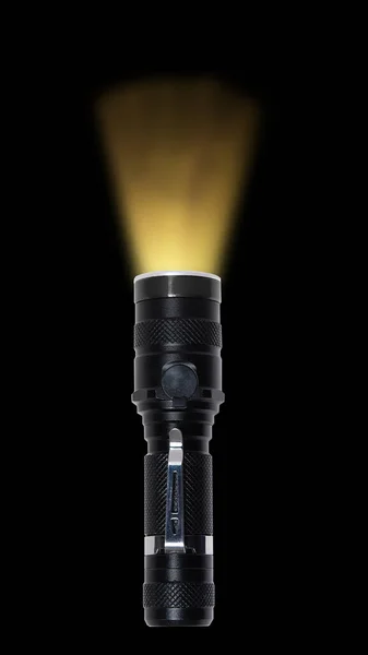 黑色金属手电筒 带有温暖的黄色光束 在黑色背景上隔离 — 图库照片