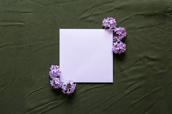 stock image Happy birthday, mother's day, wedding composition. Blank greeting card, invitation and envelope mockup. Rectangular blank with delicate lilac flowers. Flat lay, top view.