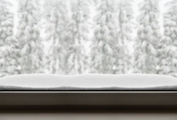 White snow on the window, banner. Blurred snow-covered fir trees in the background