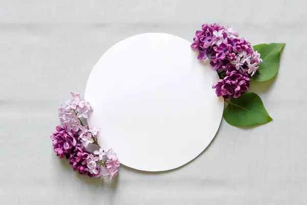White circle with flowers on a gray background. Flat lay, top view. Happy mother\'s day, women\'s day or birthday, wedding composition.