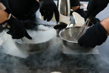 Aşçıbaşı dondurma yapıyor. Sıvı nitrojen ekliyor. Dondurma tatlısı yapma süreci.