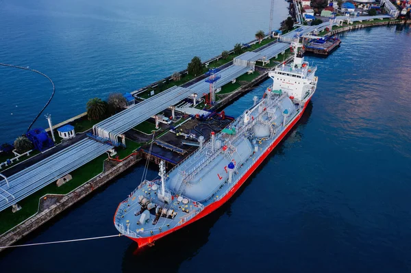 Ship tanker with LPG. Process of loading of tanker, drone aerial view