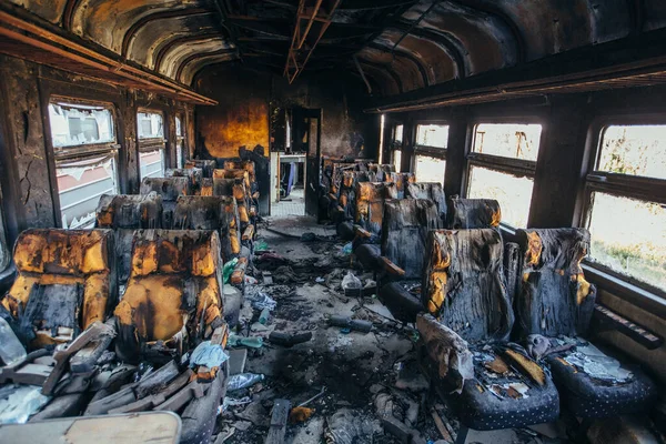 Train after fire. Burnt interior of passenger carriage. Consequences of fire or war.