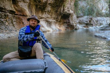 Man in rafting boat in the canyon