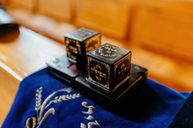 A pair of tefillin on a synagogue bench.