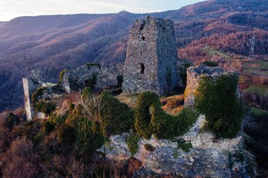 Ancient old fortress. Shkhepi Castle ruin in mountains at the sunset, aerial drone view.
