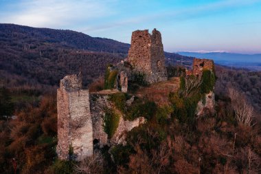 Ancient old fortress. Shkhepi Castle ruin in mountains at the sunset, aerial drone view.
