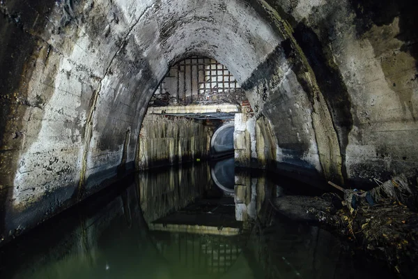 stock image Flooded underground urban sewer tunnel. Large sewage collector.