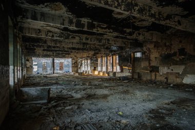 Burnt ruined industrial building. Consequences of war or fire concept.