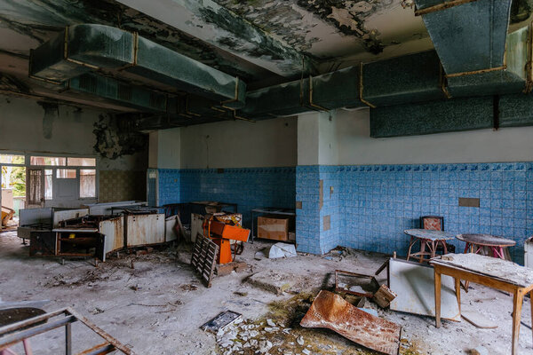 Abandoned and ruined kitchen of closed factory canteen or restaurant.