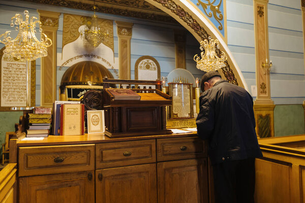 Jewish man praying in synagogue.