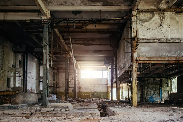 Abandoned factory. Large empty ruined industrial hall.