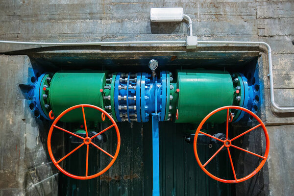 Plumbing pipe with two valves and pressure gauge. Water pressure regulation in hydroelectric power plant.
