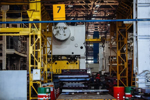 Industrial hydraulic press brake in metalworking factory.