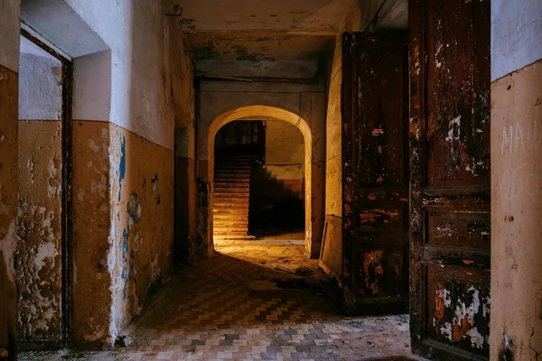 Dark vaulted corridor in old abandoned building.