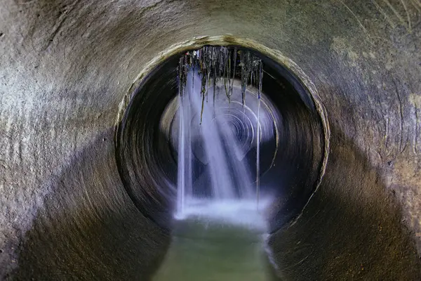 Leak of water into round sewer tunnel.