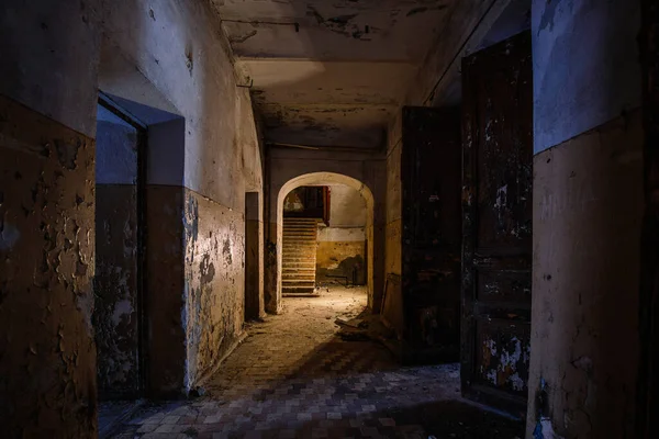 Dark creepy vaulted corridor in old abandoned building.