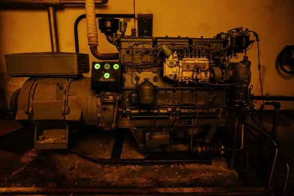 Old rusty diesel power generator in abandoned Soviet bunker.