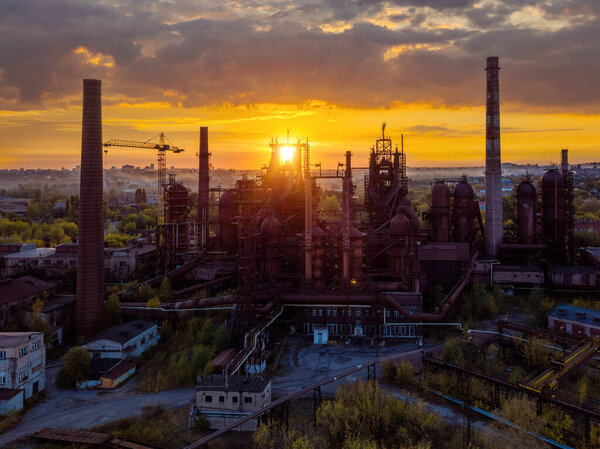 Blast furnace equipment of the metallurgical plant at the sunset, aerial view.