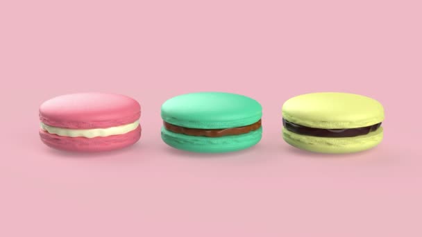 ピンクの背景に異なる色と味を持つフランスのマカロン — ストック動画