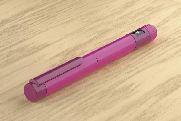Purple insulin injector pen on wooden desk