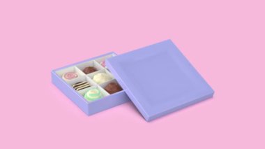 Pembe arka planda çikolatalı pralinler içeren bir hediye kutusu.