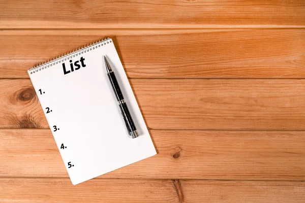 stock image pen and white sheet of paper on wooden background