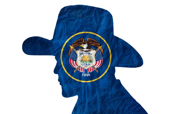 カウボーイシルエットとともにユタ州旗上のしわ紙の背景 — ストック写真
