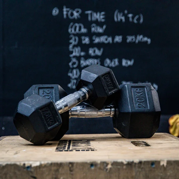 Closeup Two Dumbbells Wooden Box Front Blackboard Gym Wod Workout — Stock Photo, Image