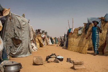 Refugee IDP camp (IDP - Internal displaced person) taking refuge from armed conflict.  People staying in very poor living conditions in huts made of clothing and plastic sheeting, lack of water, hygiene, shelter and food clipart