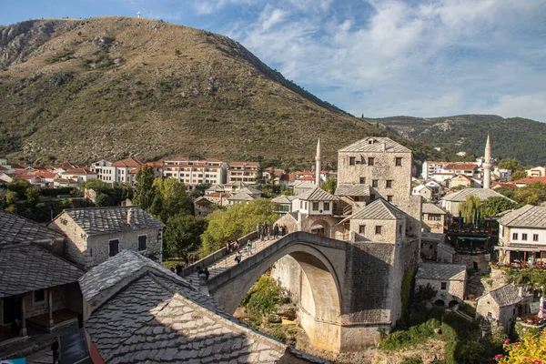 stock image Sunbathed Old bridge (Stari Most) in Mostar city, southern Bosnia and Herzegovina, a testament to time's enduring embrace, spans the azure waters below, its weathered stones narrating centuries of history and bridging the past with the present.