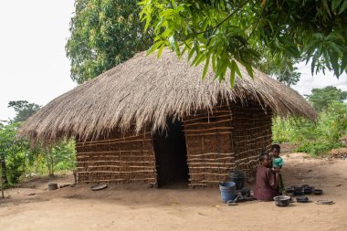 Afrika 'nın ücra bir köyünde sazdan çatılı, çok basit ve kötü yaşam koşulları olan tipik bir kırsal çamur evi.