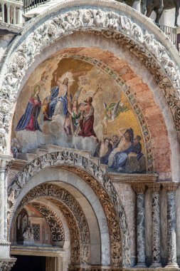 Details of St Mark's Basilica or the Basilica di San Marco in Italian, golden mosaics, intricate carvings, and statues adorn the roof of St. Mark's Basilica, a true marvel of Byzantine art in Venice.