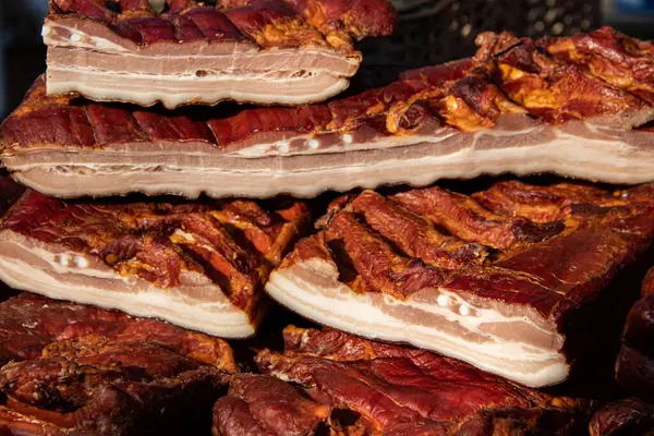 Exposed bacon and dried meat domestic products presented for sale on a farmer's market in Kacarevo village, gastro bacon and dry meat products festival called Slaninijada (bacon festival) held yearly in Kacarevo, near Belgrade