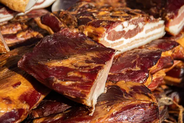 Exposed bacon and dried meat domestic products presented for sale on a farmer\'s market in Kacarevo village, gastro bacon and dry meat products festival called Slaninijada (bacon festival) held yearly in Kacarevo, near Belgrade