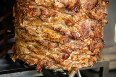 Taze domates, soğan ve kremalı tzatziki sosuyla kaplanmış lezzetli baharatlı et dilimleri, sıcak bir pidaya sarılmış. Bir Akdeniz lezzeti, tatmaya hazır.