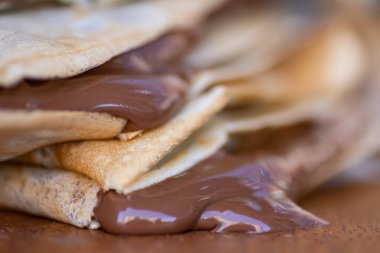 Bir grup ev yapımı krep. İçi erimiş sıcak çikolatayla dolu. Masadan çikolata damlıyor.