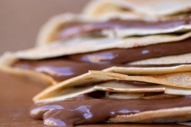 Bir grup ev yapımı krep. İçi erimiş sıcak çikolatayla dolu. Masadan çikolata damlıyor.