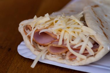 Jambon ve erimiş peynirle dolu leziz bir krep lezzetli bir lezzet kombinasyonu sunar. Gözlemenin altın gibi, çıtır çıtır dışı doyurucu ve doyurucu bir yemek için sıcak ve lezzetli bir dolgu içerir..