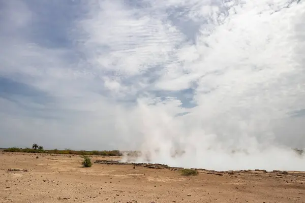 stock image Alolabad geothermal area in Ethiopia with surreal landscape of colorful hot springs, steaming fumaroles, and erupting salt geysers in an arid, remote desert setting below sea level, Afar desert. Temperature of water is up to 112C 