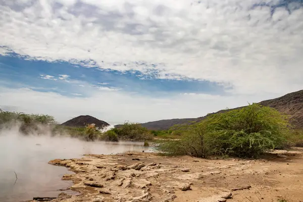 stock image Alolabad geothermal area in Ethiopia with surreal landscape of colorful hot springs, steaming fumaroles, and erupting salt geysers in an arid, remote desert setting below sea level, Afar desert. Temperature of water is up to 112C 