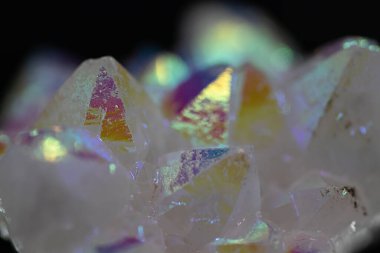 A rainbow aura quartz crystal cluster radiates vibrant, iridescent hues, combining natural beauty with mystical energy and gemstone brilliance, isolated in studio clipart