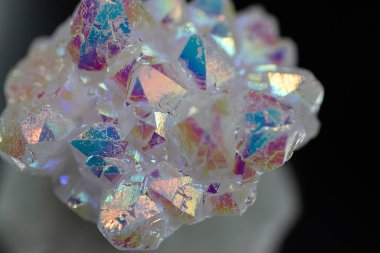 A rainbow aura quartz crystal cluster radiates vibrant, iridescent hues, combining natural beauty with mystical energy and gemstone brilliance, isolated in studio clipart