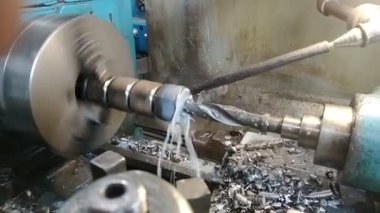 Dönen torna makinesinde metal bir silindiri kesen matkabın yakın çekimi. Yüksek kaliteli FullHD görüntüler